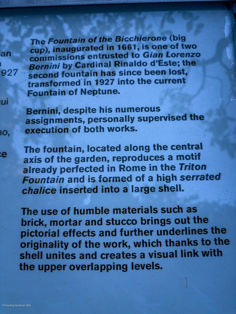 Blue informational sign describing the Fountain of the Bicchierone, its commission by Bernini and its design features used in a garden setting.
